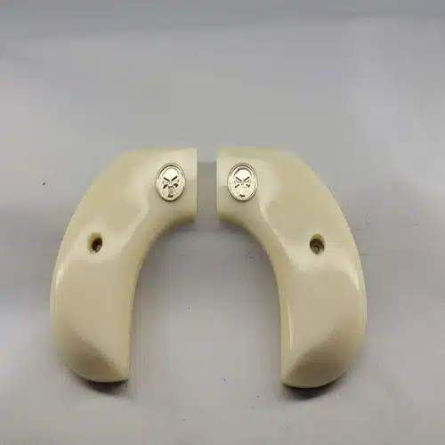 Ruger Wrangler grips in faux ivory acrylic with silver Punisher medallion — birdshead frame fit
