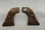 Ruger Wrangler walnut grips with laser-carved scrollwork and black Punisher medallion