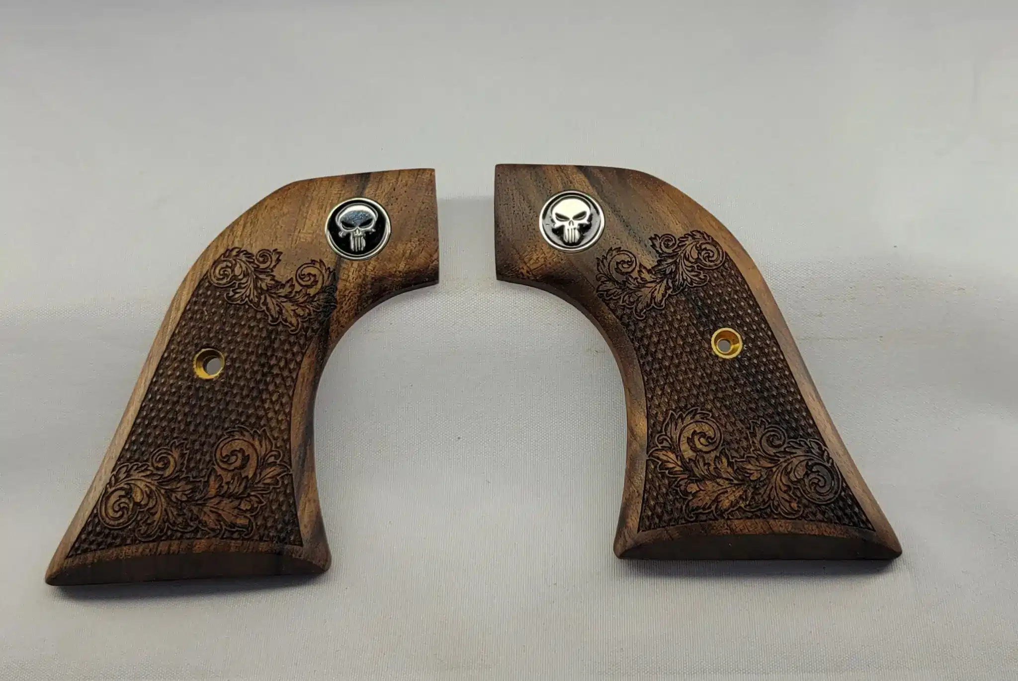 Ruger Wrangler walnut grips with laser-carved scrollwork and black Punisher medallion