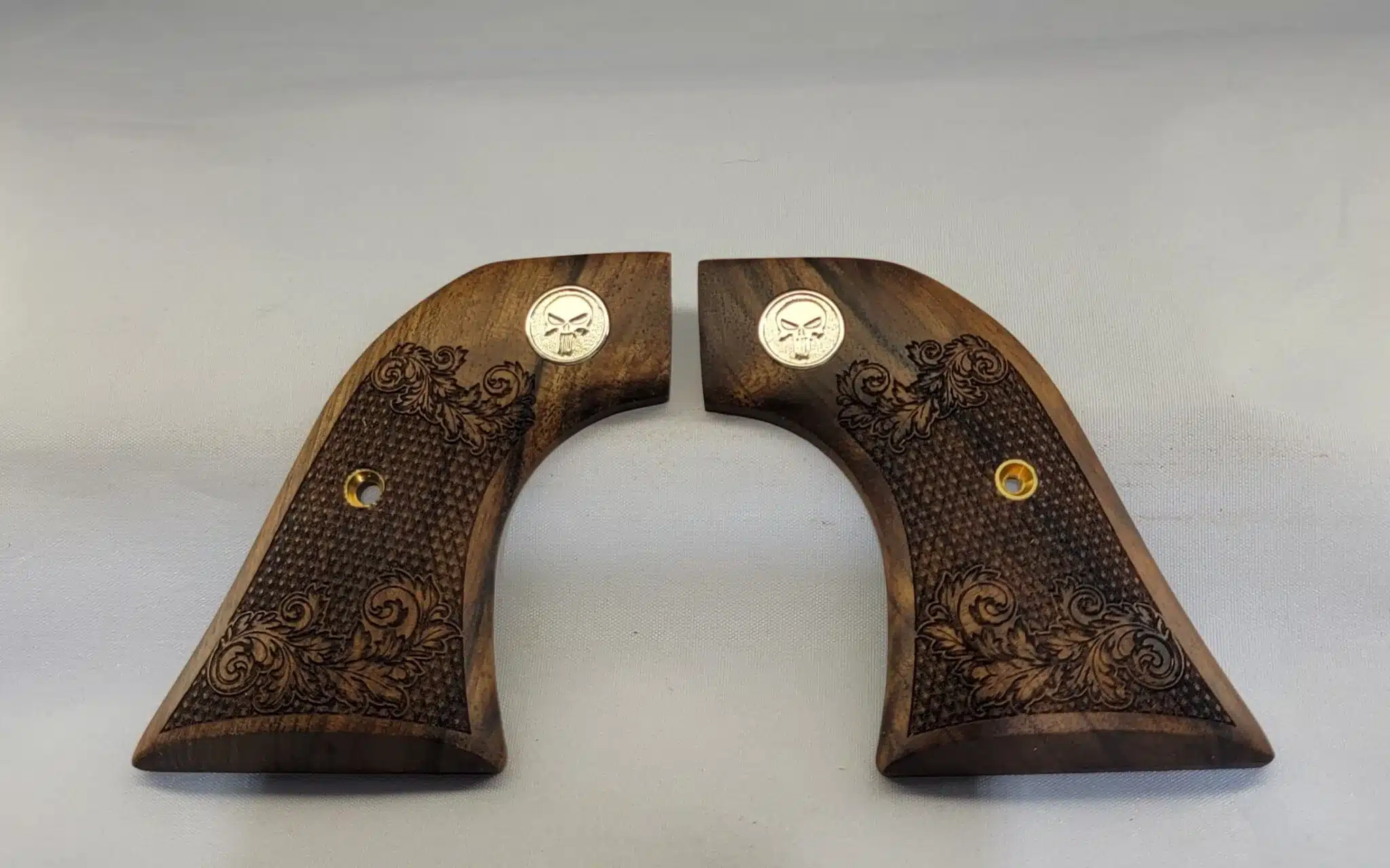 Ruger Wrangler walnut grips with laser-carved scrollwork and silver Punisher medallion